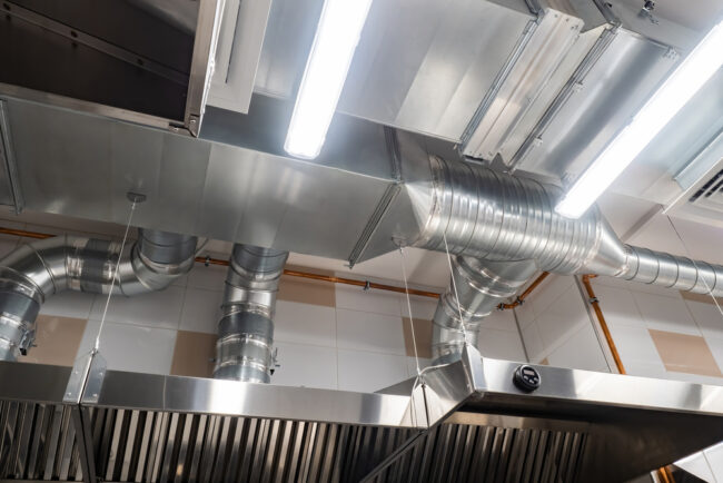 Technician servicing a commercial kitchen exhaust fan – ProServe Mechanical