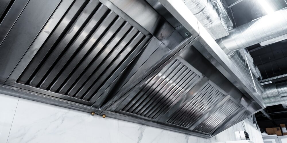 technician installing commercial kitchen exhaust hood – ProServe Mechanical technician installing commercial kitchen exhaust hood – ProServe Mechanical