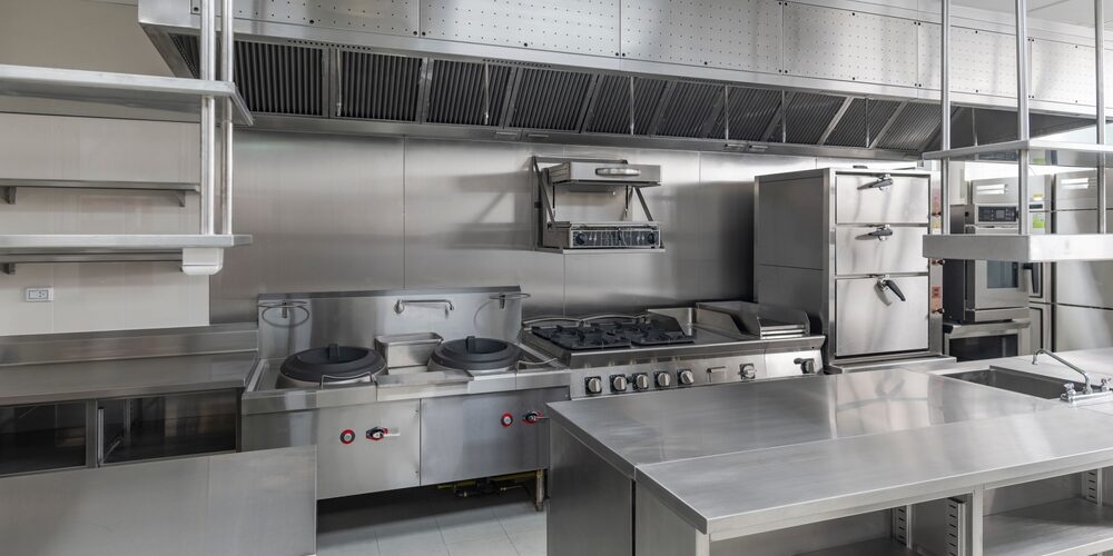 Technician opening kitchen exhaust access panel for maintenance – ProServe Hoods